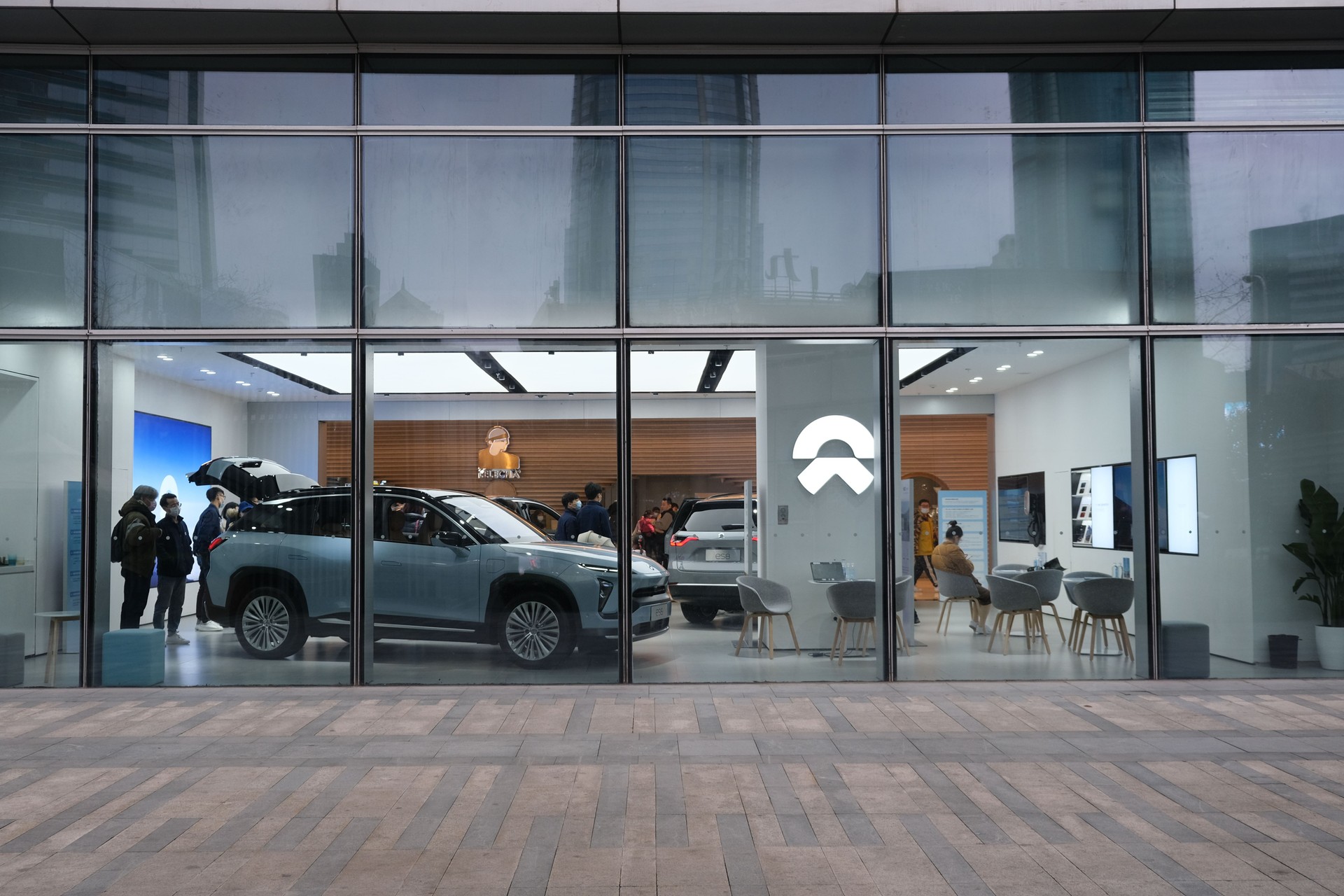 exterior of NIO electric car store. Customers inside store choosing electric car